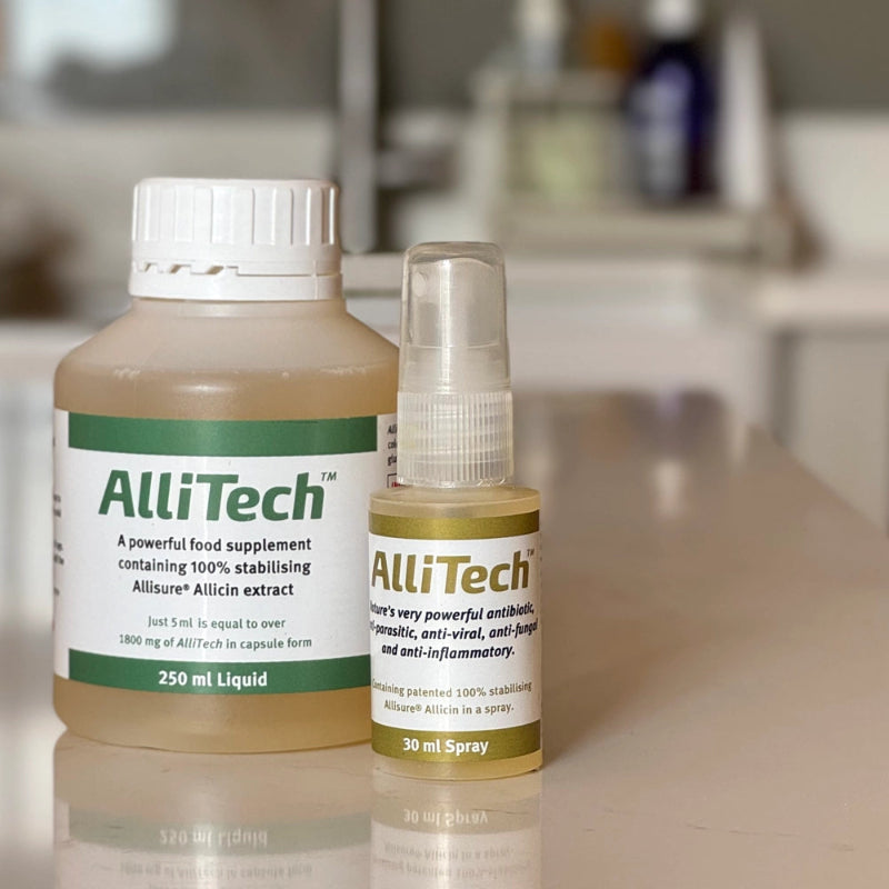 Two old AlliTech products on a reflective surface with a blurred background