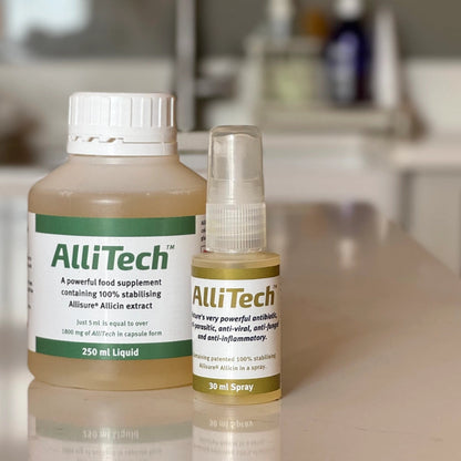 Two old AlliTech products on a reflective surface with a blurred background