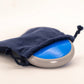 Blue and grey Geomack G-Osyter device with a drawstring bag on a white background