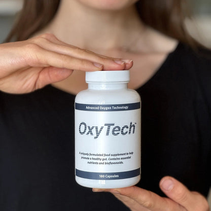 Person holding an OxyTech 180 supplement bottle