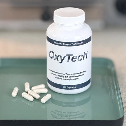 OxyTech 180 supplement bottle with capsules on a green tray