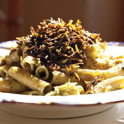 Pasta dish with Seagreens Pelvetia Pieces on a white plate